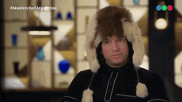 a man wearing a fur hat with the hashtag masterchefargentina