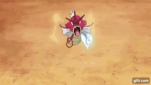 a red and white pokemon with its mouth open is holding a blue flame in its mouth .