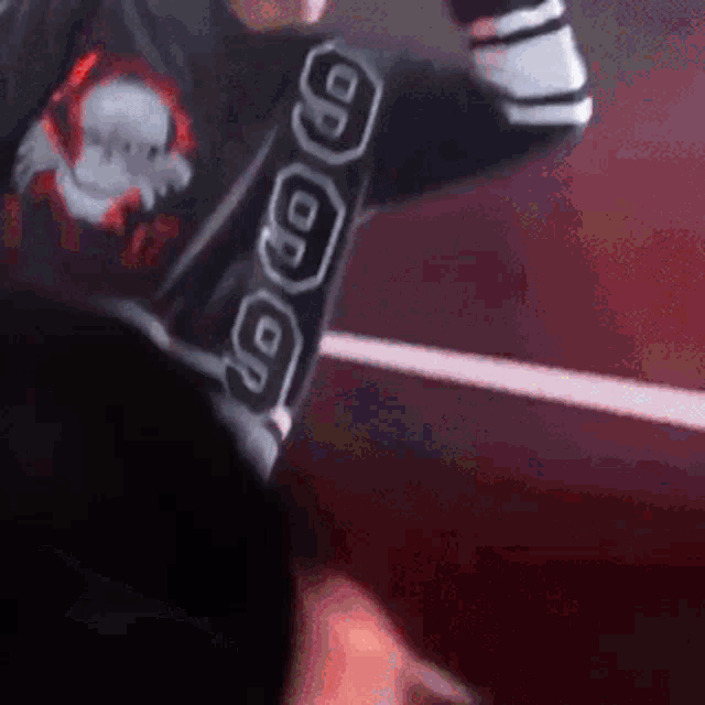 a close up of a person wearing a black shirt with a skull on it
