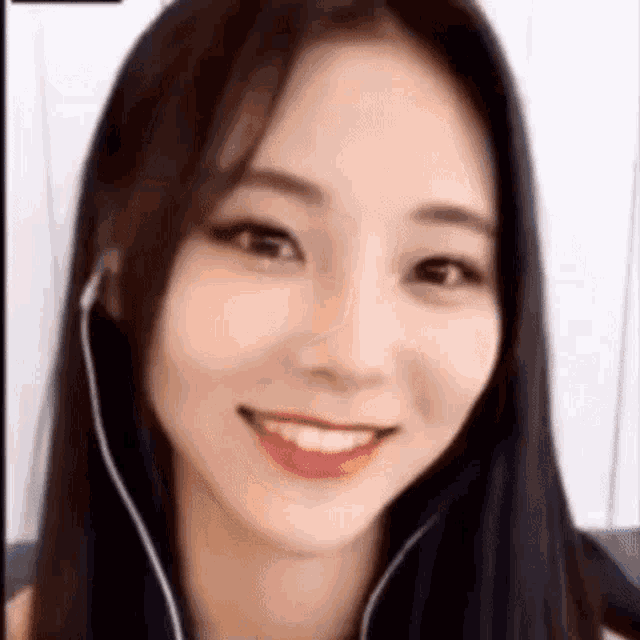a close up of a woman 's face with headphones on .