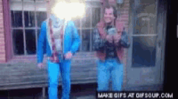 a couple of men standing in front of a building with the words make gifs at gifsoup.com below them