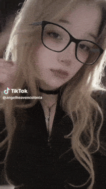 a girl wearing glasses and a choker has a tiktok account named angelheavencolonia