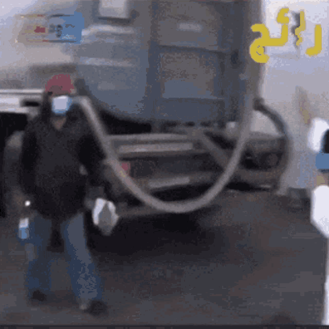 a man wearing a mask is standing next to a truck