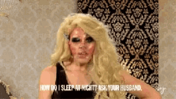 a woman with long blonde hair is talking to her husband .