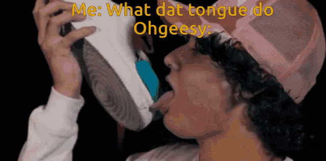 a man in a pink hat is licking his shoe