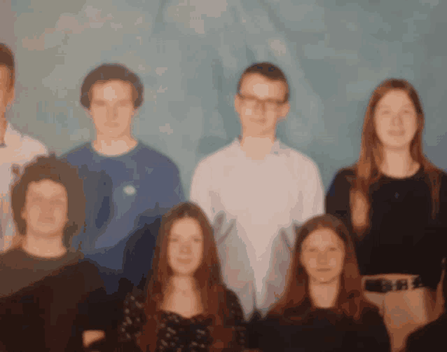 a group of people posing for a picture with a blurry background