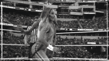 a black and white photo of a woman in a wrestling ring with the word wrestlemania on the bottom