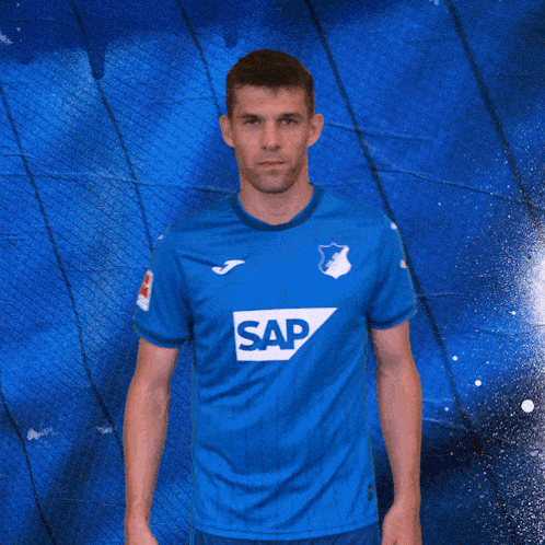a man in a blue shirt with the number 2 on the back