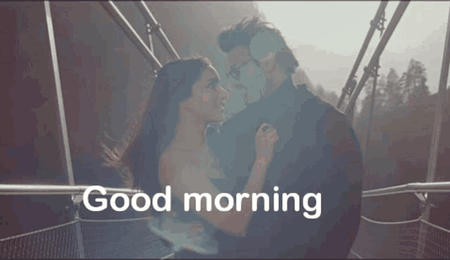 a picture of a man and woman kissing with the words good morning in the corner