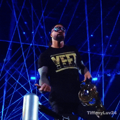 a man wearing a shirt that says vf3 is holding a trophy