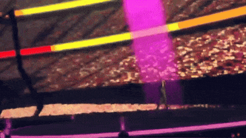a purple glow stick is being thrown in the air by a person