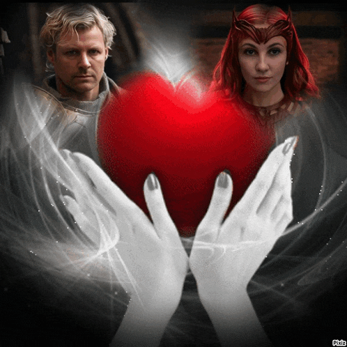 a picture of a man and a woman holding a large red heart
