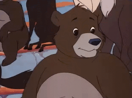 a cartoon bear is smiling in a group of animals .