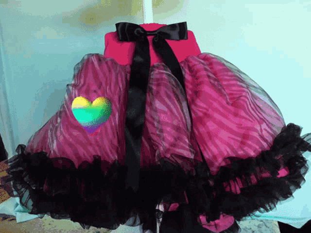 a pink and black dress with a heart on the back