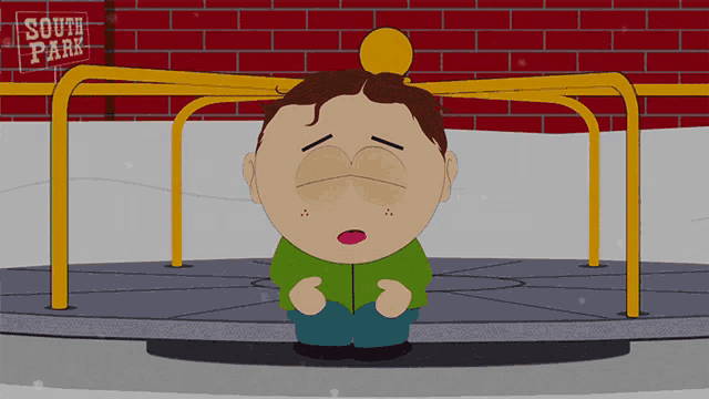 a cartoon character from south park sits on a merry go round in front of a sign that says south park