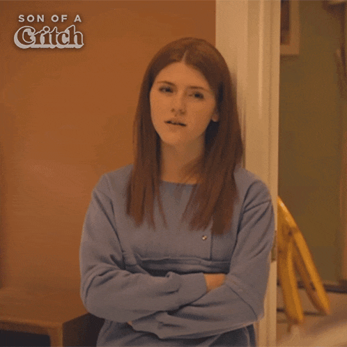 a woman is standing in front of a door with her arms crossed and the words i think i got it below her
