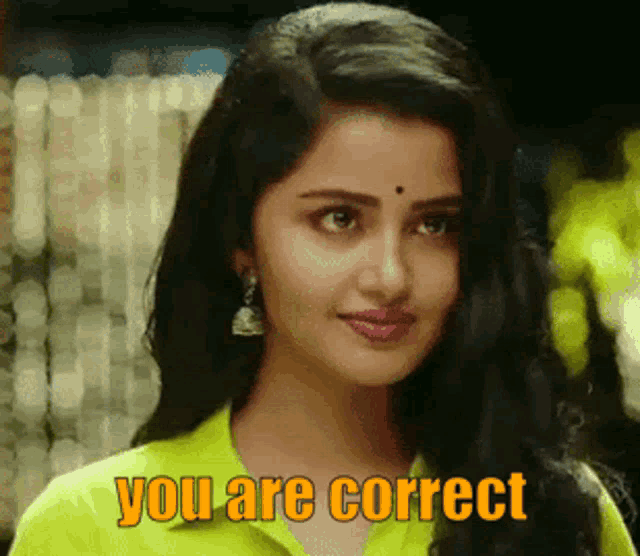 a woman in a yellow shirt is smiling and says you are correct .