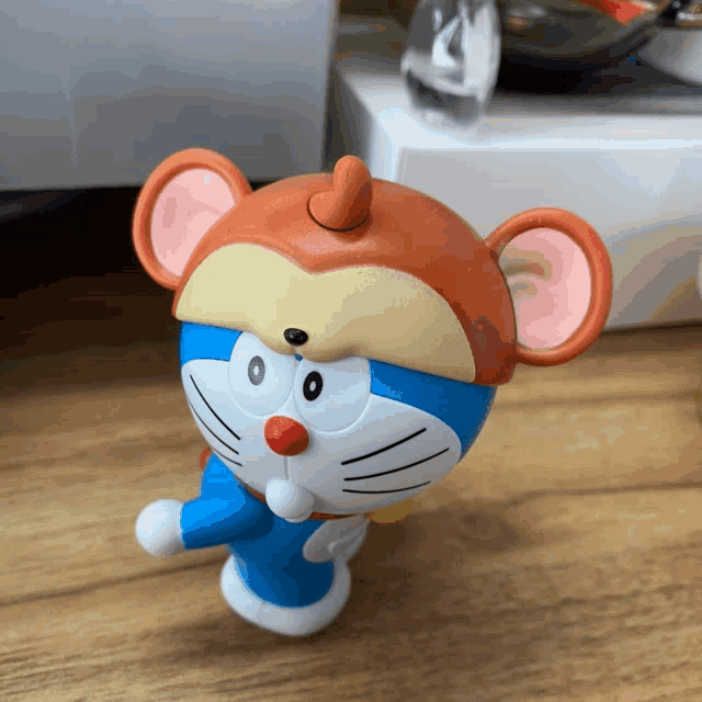 a figurine of doraemon wearing a monkey hat