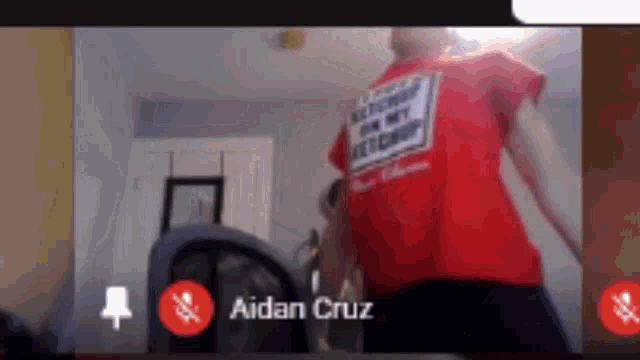 a man in a red shirt is on a video call with a dan cruz