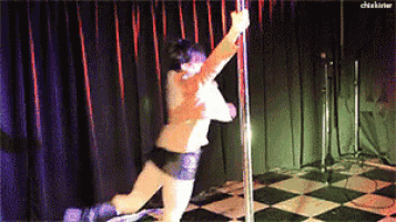 a woman is dancing on a pole in front of a checkered floor and a curtain with the word chiakirter on it