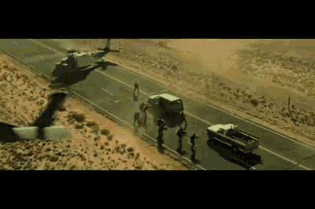an aerial view of a helicopter flying over a road
