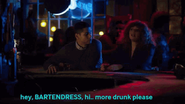 a man and a woman are sitting at a bar and the man is saying hey bartenders hi more drunk please
