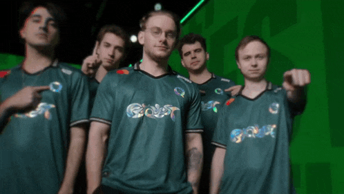 a group of men wearing green shirts with the word goat on the front