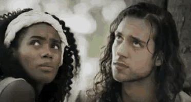 a man and a woman are looking at each other .