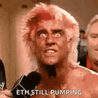 a man with a mohawk is talking into a microphone and says `` eth still pumping '' .