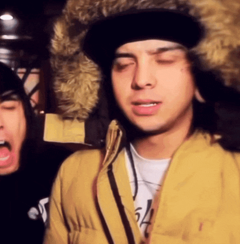 a man wearing a fur hat and a yellow jacket with the number 54 on his shirt