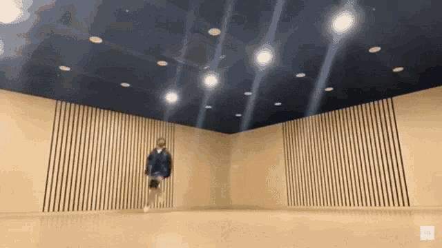 a person is jumping in the air in an empty room