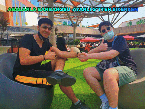 two men shaking hands in front of a sign that says agalarla barbarosu ayarlig'ten sirken