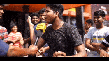 a group of people are standing around a man with a microphone that says chennai health