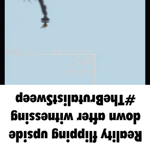 a statue of liberty is hanging upside down on a blue background
