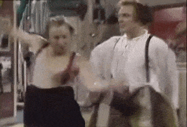 a man and a woman are dancing together in a room in a room .