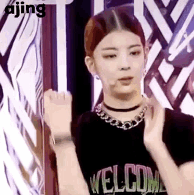 a woman wearing a black shirt and a choker is standing in front of a mirror .