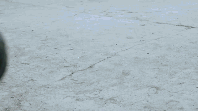 a blurry picture of a person 's feet on a concrete floor