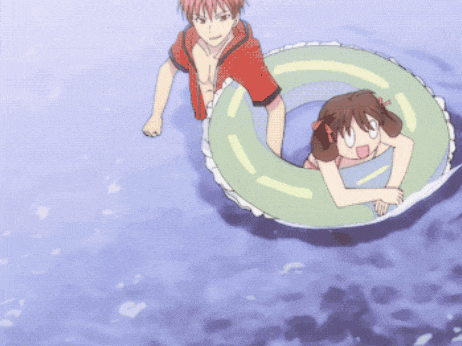a boy and a girl are playing in the water with a green float