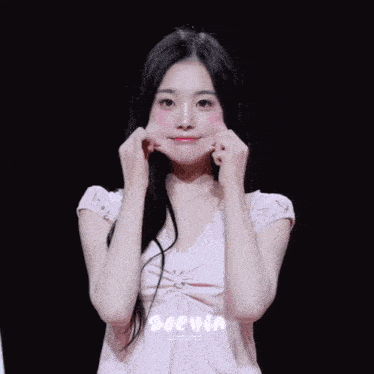 a woman in a pink dress making a funny face