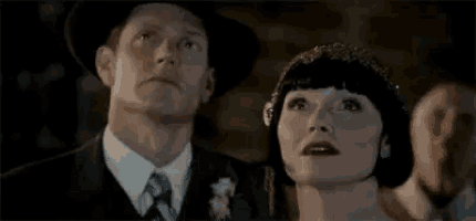 a man and a woman are looking up at the sky .