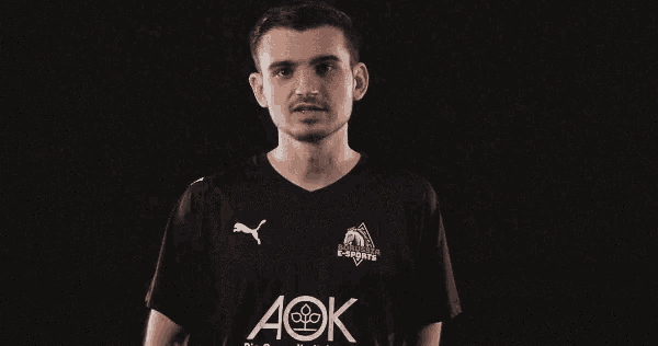 a man wearing a black shirt with aok written on it