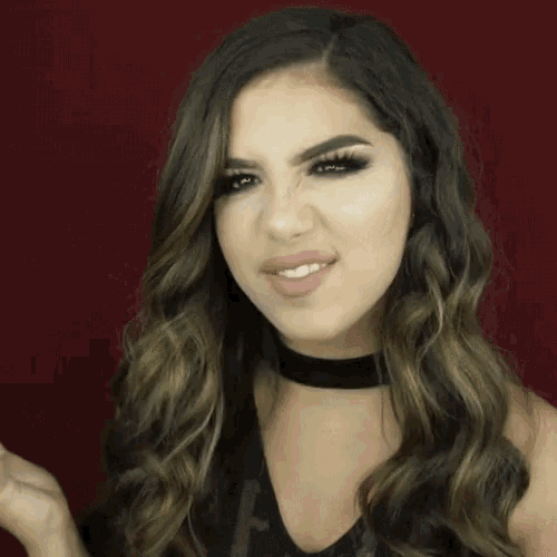 a woman with long hair is smiling with the word very behind her
