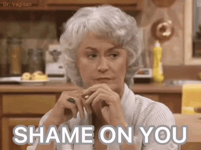a woman sitting in a kitchen with the words " shame on you " written on her face