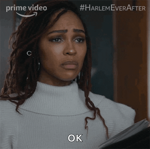 a woman in a white sweater with dreadlocks says ok