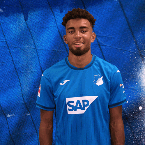 a man is wearing a blue shirt with the word sap on it
