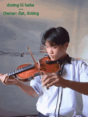 a young man is playing a violin with the words owner : dat , duong behind him