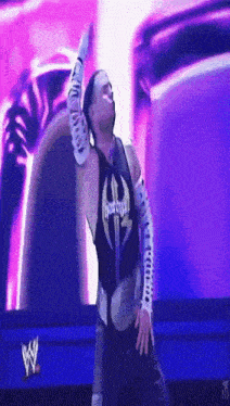 a wrestler wearing a black shirt that says ' hardy ' on it