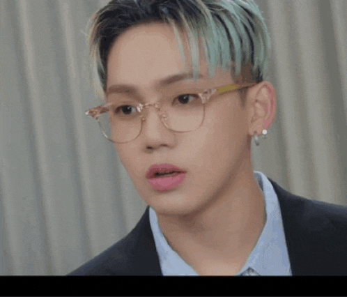 a close up of a person wearing glasses and earrings with the word baby above them