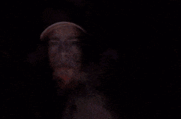 a man with smoke coming out of his nose wearing a baseball cap