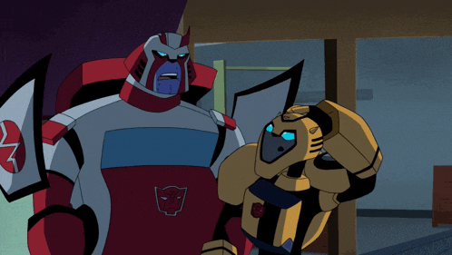 two transformers are standing next to each other and one of them has a red and white shirt on